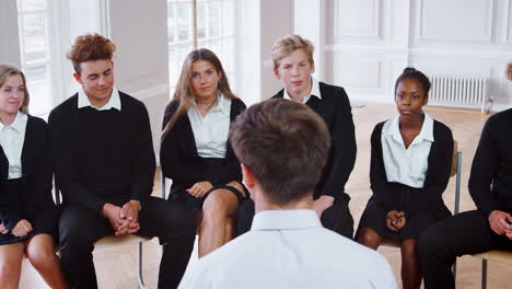 Group-Of-Teenage-Students-Having-Discussion-With-Tutor