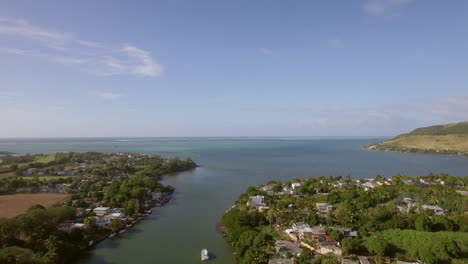 Coastal-town-and-river-falling-into-ocean-Mauritius-aerial-view