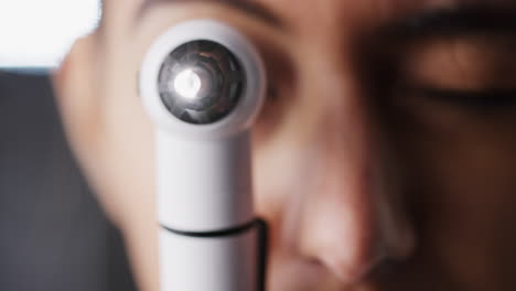 Woman-using-otoscope-for-an-examination,-close-up
