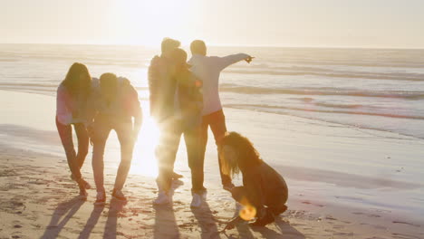 Group-Of-Friends-Having-Fun-On-Winter-Beach-Together