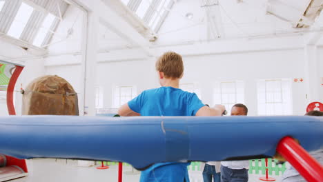 Kids-watch-boy-in-centrifugal-experiment-at-a-science-centre