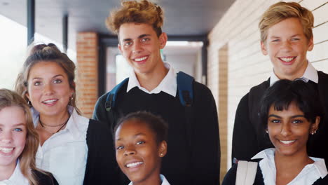 Portrait-Of-Teenage-Students-In-Uniform-Outside-School-Building