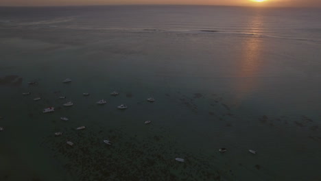 Aerial-view-of-yachts-at-anchor-and-ocean-at-sunset