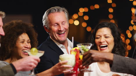 Group-Of-Middle-Aged-Friends-Celebrating-In-Bar-Together