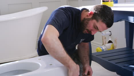 Plumber-Cleaning-New-Toilet-Basin-Before-Fitting