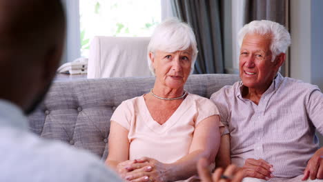 Happy-senior-couple-taking-financial-advice-at-home
