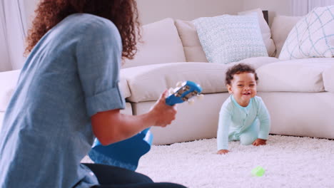 Black-toddler-boy-crawling-to-his-mum-playing-ukulele