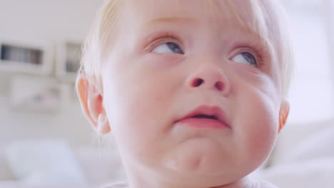 White-toddler-boy-making-face,-reaching-to-camera,-close-up