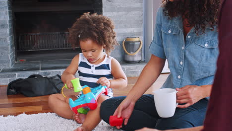 Young-black-girl-playing-on-the-floor-with-her-mother