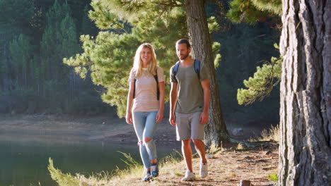 Couple-On-Countryside-Hike-Walking-Through-Woods-By-Lake