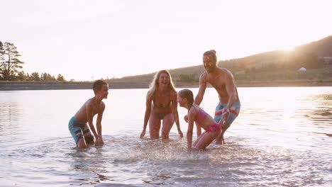 Parents-With-Children-Playing-And-Splashing-In-Lake