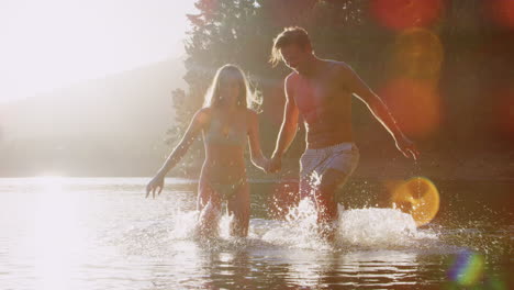 Young-white-couple-wading-and-having-fun-in-a-lake