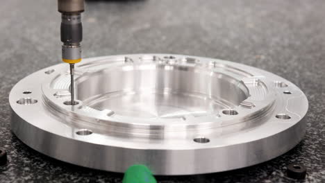 Close-Up-Of-Precision-Measuring-Machine-Checking-Component-In-Engineering-Plant