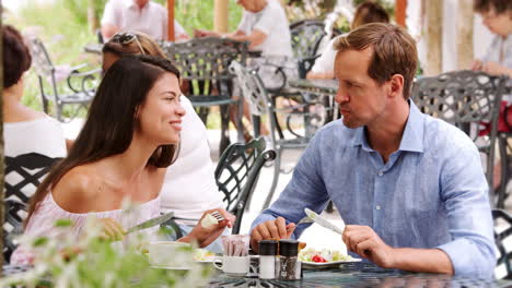 Young-white-adult-couple-having-lunch-together-outside-cafe