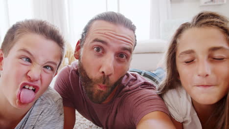 Point-Of-View-Shot-Of-Father-And-Children-Posing-For-Selfie