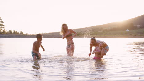 Parents-With-Children-Playing-And-Splashing-In-Lake