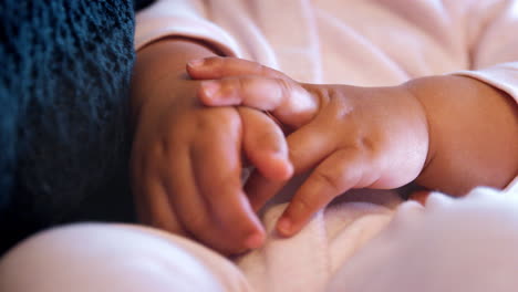 Close-Up-Of-Baby-Girls-Hands-As-She-Is-Held-By-Father