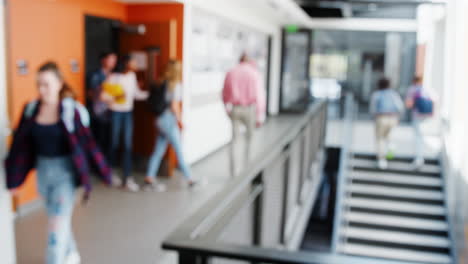 Defocused-Shot-Of-Busy-High-School-Corridor-During-Recess-With-Students-And-Staff