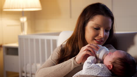 Mother-In-Nursery-Feeding-Newborn-Baby-From-Bottle