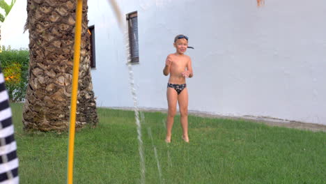 Mum-with-son-frolicking-with-hose-outdoor