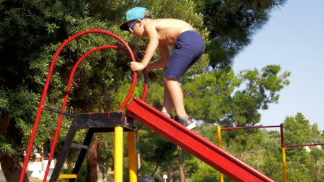 Outdoor-children-activities-Kid-climbing-slider-at-playground