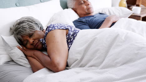Senior-Couple-Sleeping-In-Bed-In-Morning