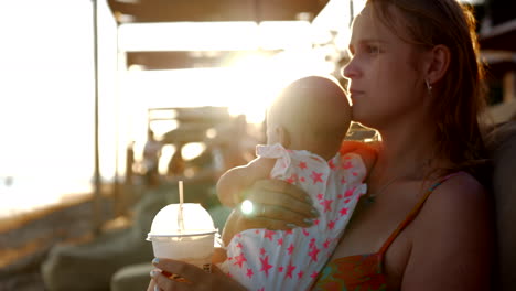 Mother-with-baby-on-summer-vacation-at-the-seaside