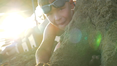 Kid-having-fun-at-seaside-and-making-sandcastle