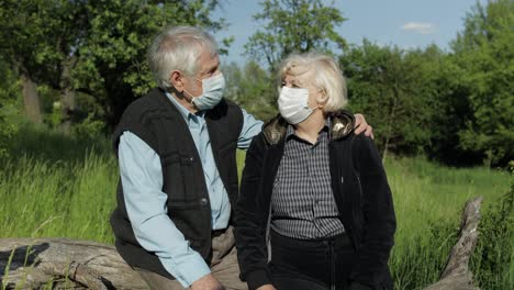 Senior-couple-in-medical-masks-during-COVID-19-coronavirus-quarantine-in-park