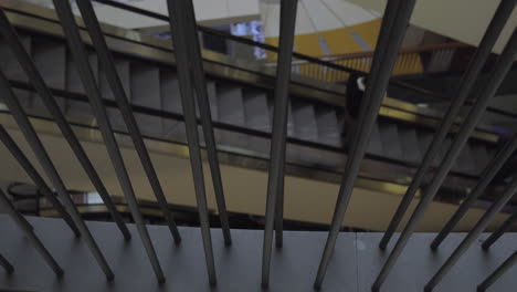 A-slow-motion-of-a-moving-escalator-with-a-man-on-it