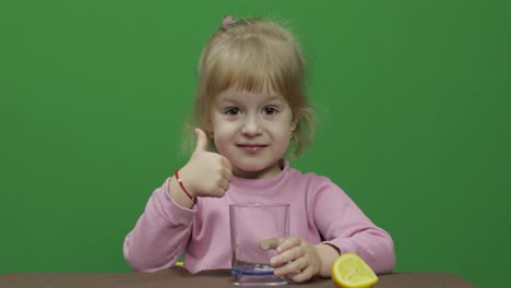 Beautiful-young-girl-squeezes-lemon-juice-and-drinks-it-with-a-grimace-on-face