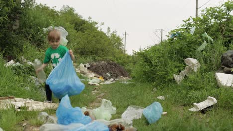 Volunteer-girl-cleaning-up-dirty-park-from-plastic-bags,-bottles.-Reduce-trash-nature-pollution