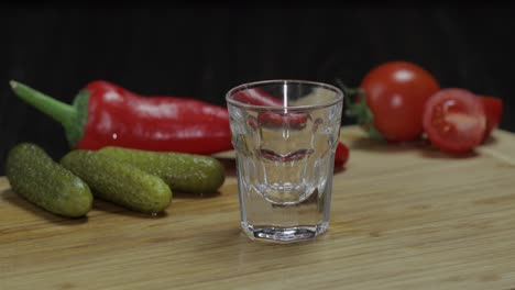 Man-puts-a-glass-then-fills-it-with-vodka-and-picks-up-a-glass