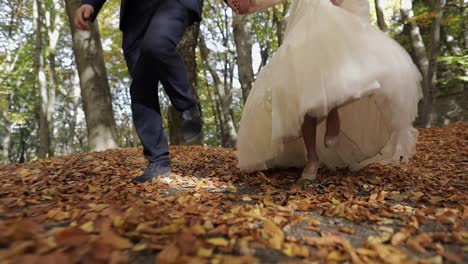 Legs-of-groom-with-bride-in-the-forest-park.-Wedding-couple.-Happy-family