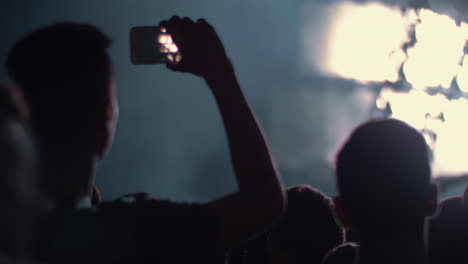 Music-fan-shooting-cellphone-video-of-the-concert