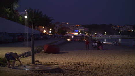 Beach-with-people-in-resort-town-at-night-Greece