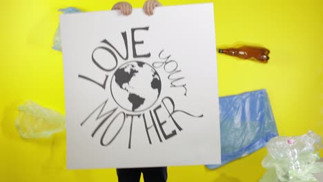 Girl-activist-holding-poster-Love-Your-Mother-Earth.-Plastic-nature-pollution