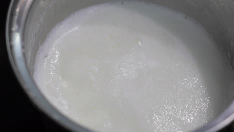 Adding-flakes-to-pot-with-boiling-milk.-High-energy-morning-food