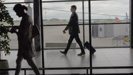 People-walking-in-terminal-against-the-window-at-Sheremetyevo-Airport-in-Moscow