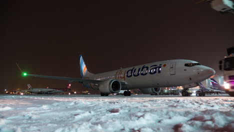 Timelapse-of-de-icing-FlyDubai-plane-at-winter-night-in-Sheremetyevo-Airport