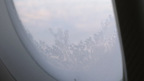 Frozen-glass-of-illuminator-in-flying-airplane
