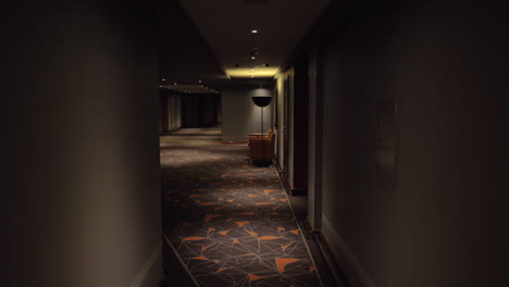 Walking-in-hotel-hallway-with-dim-light