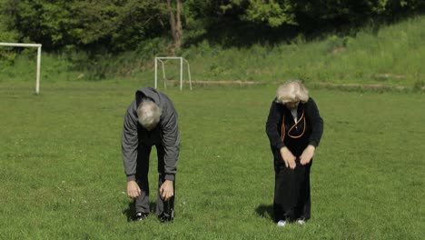 Active-senior-old-couple.-Man-and-woman-do-stretching-physical-exercises