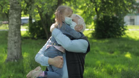 Grandfather-with-granddaughter-takes-off-masks-after-coronavirus-quarantine-end