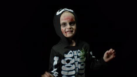 Halloween-angry-girl-with-blood-makeup-on-face.-Kid-dressed-as-scary-skeleton,-dancing,-making-faces