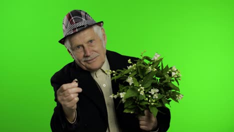 Elderly-caucasian-grandfather-man-with-bouquet-of-flowers-and-ring-goes-on-date