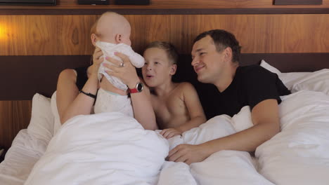Parents-with-baby-and-elder-son-in-bed