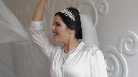 Beautiful-and-lovely-bride-in-night-gown-and-veil.-Wedding-morning.-Slow-motion