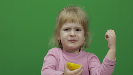Beautiful-young-girl-eats-a-lemon-with-a-grimace-on-her-face.-Chroma-Key