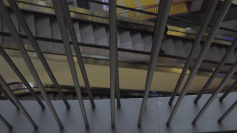 A-moving-escalator-visible-through-fence-bars